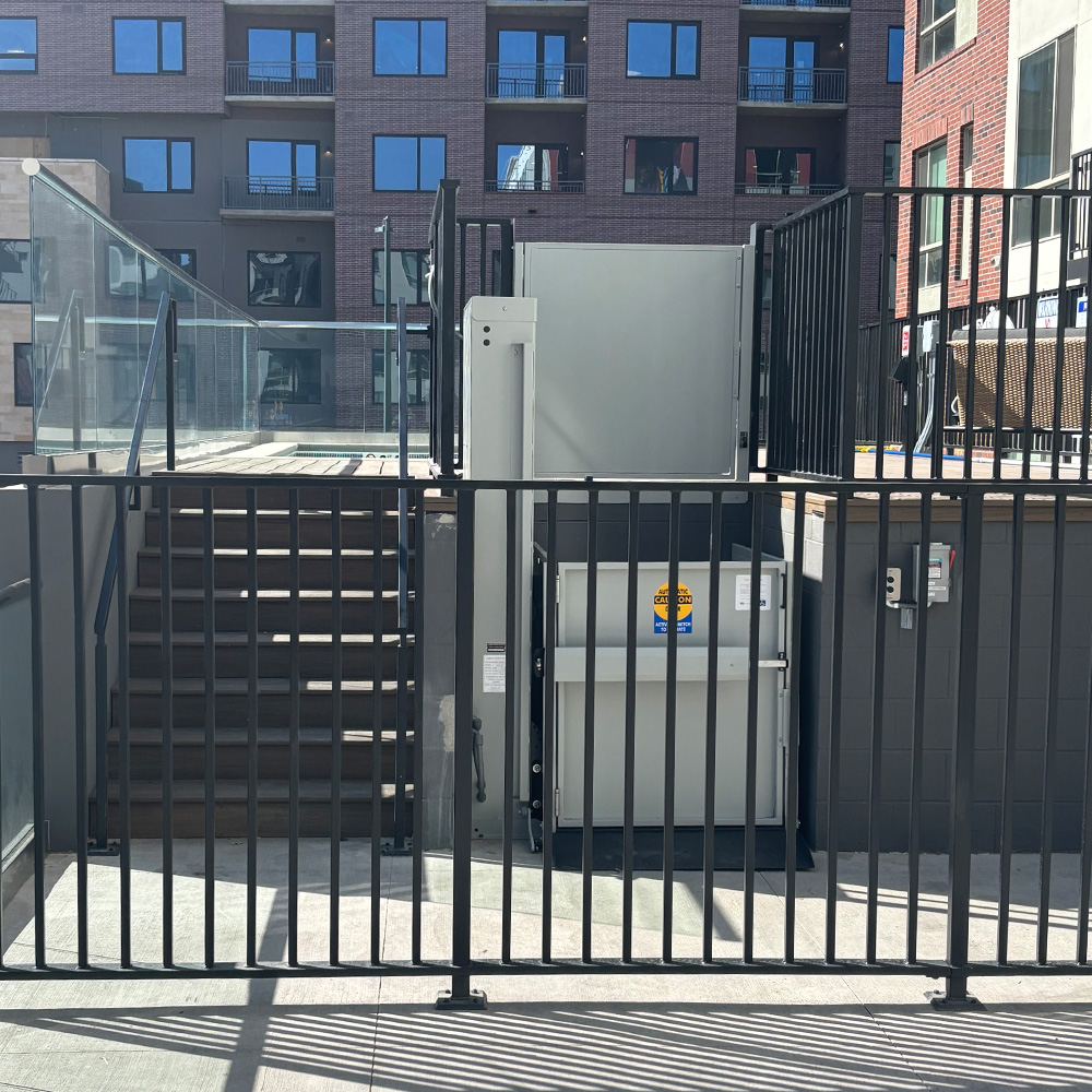 vertical platform lift providing accessibility access at a public pool installation in Colorado
