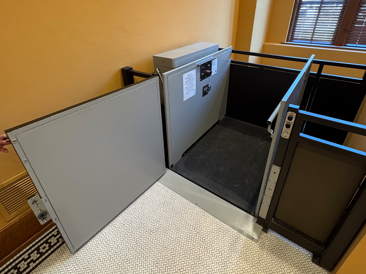 vertical wheelchair lift installed in a municipal building accessibility project in Colorado